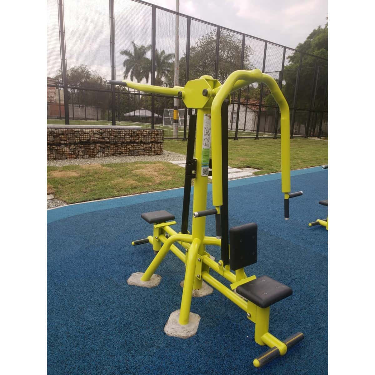 Prensa de pecho doble de TMGYM, vista frontal sobre piso azul
